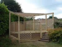 A raised deck covering an otherwise unusable corner of the garden